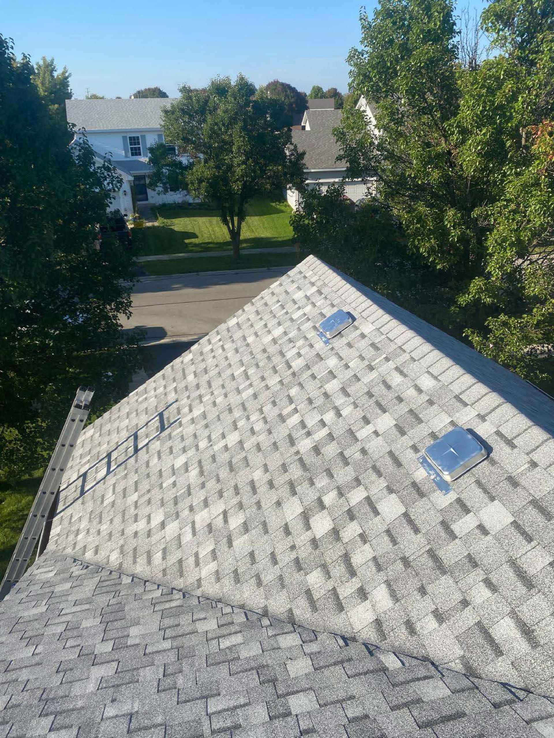 An aerial view of a roof with trees in the background.