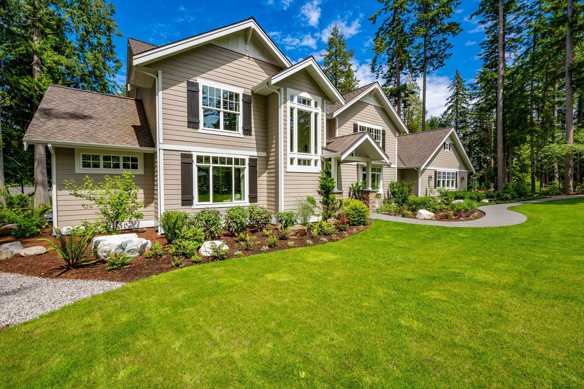 A large house with a lush green lawn in front of it.