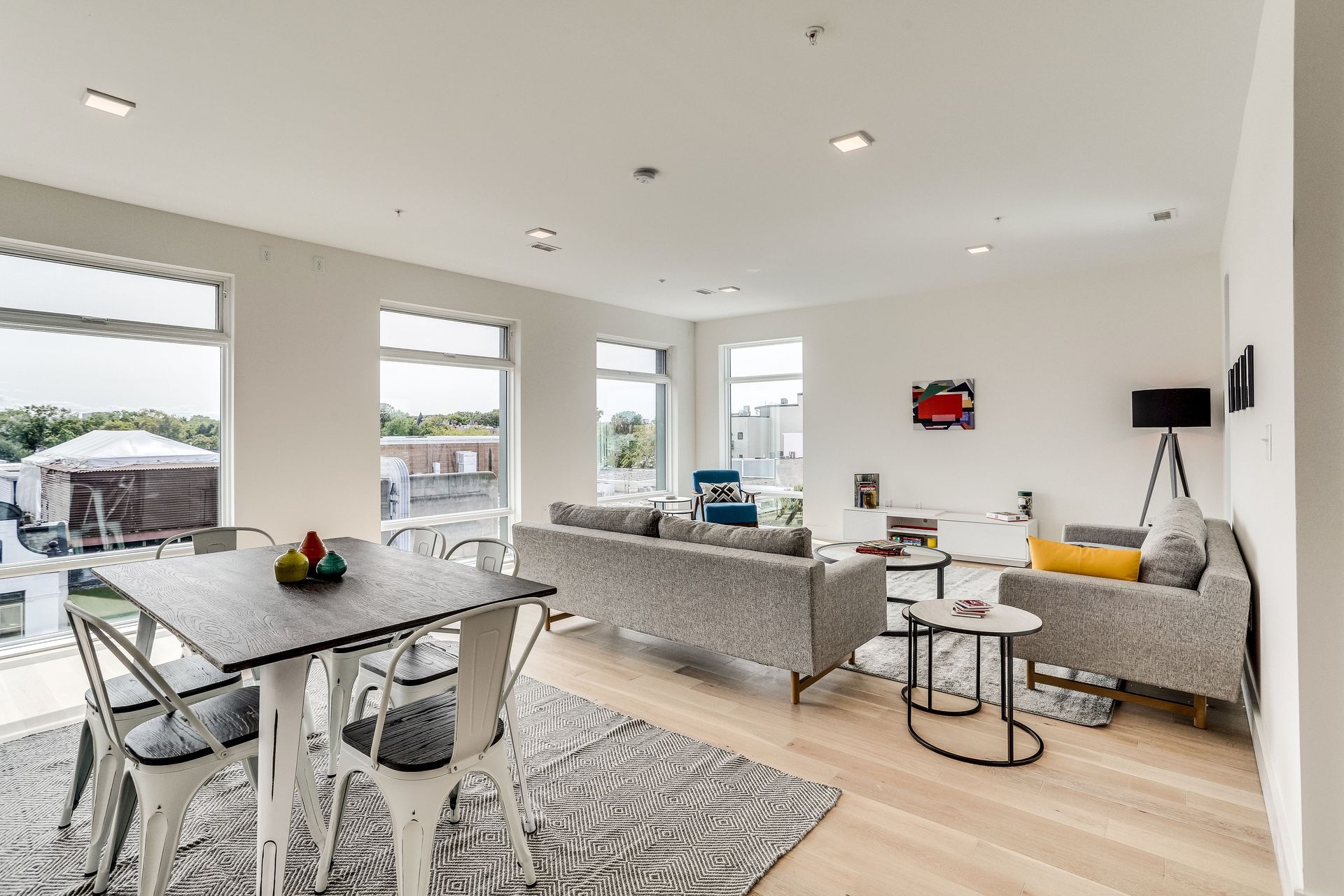A living room with a dining table and chairs and a couch.