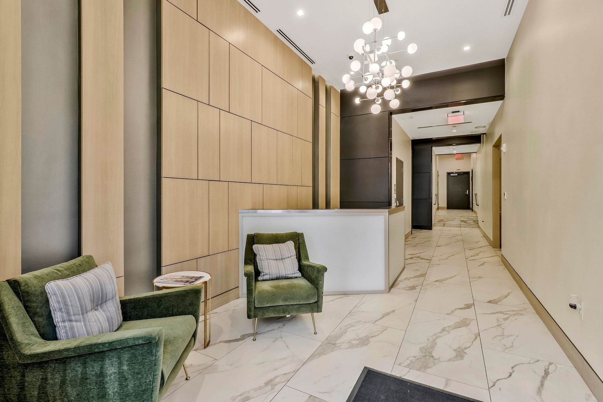 A lobby with a chair and a table in it