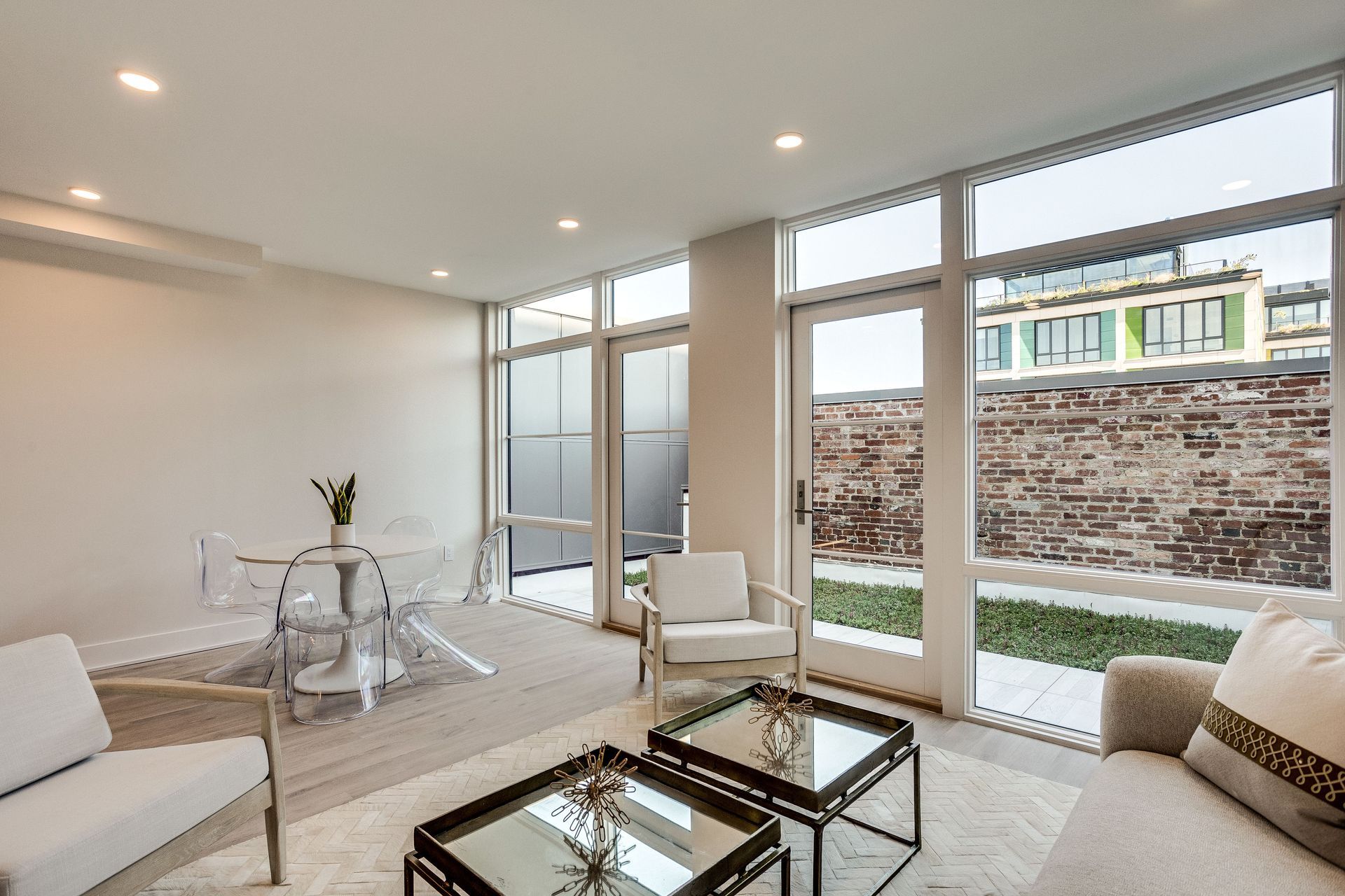 A living room with a couch , chairs , and two coffee tables.