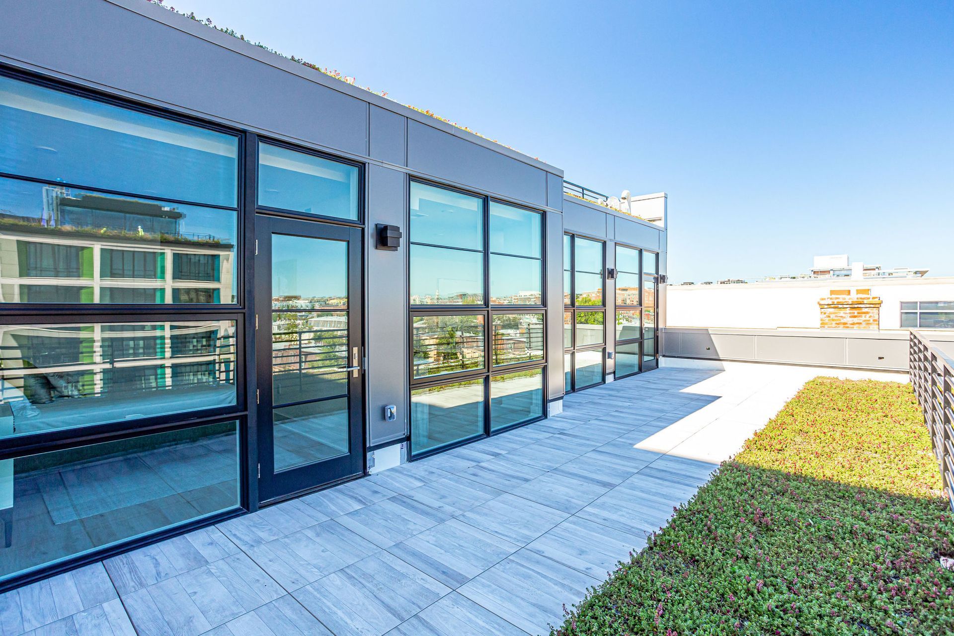 A large building with a lot of windows and a patio.