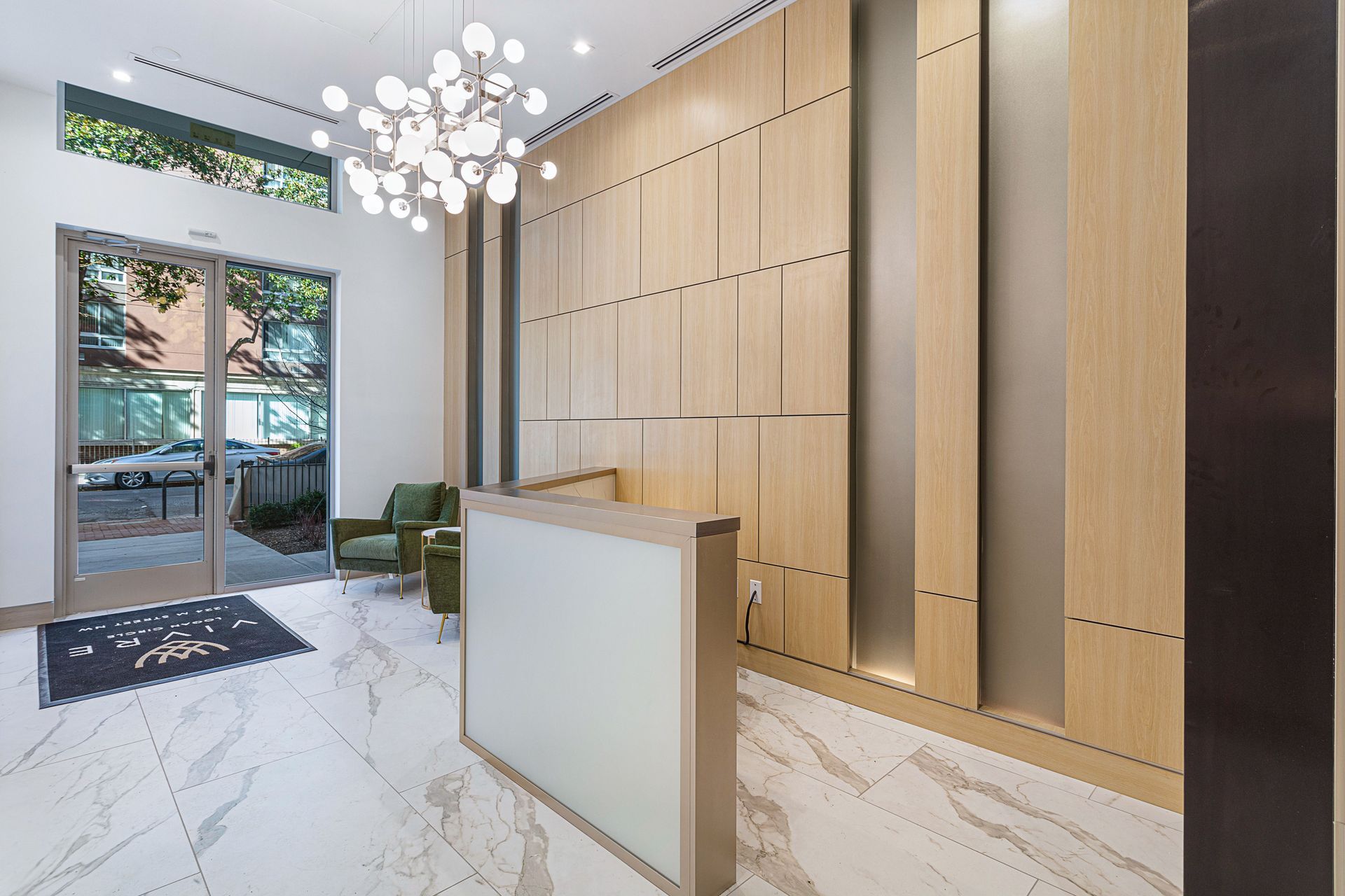 A lobby with a white counter and wooden walls