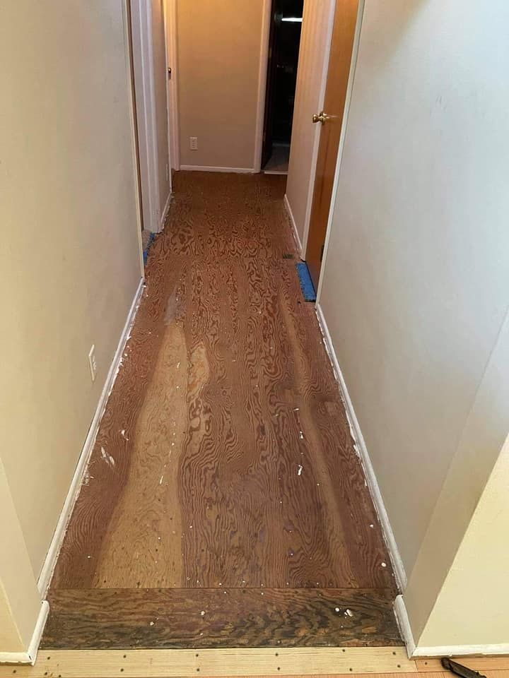 Cork flooring in a hallway, with white trim along walls. Two doors are visible.