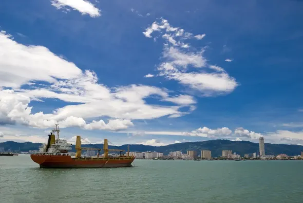 A large ship is in the middle of a large body of water
