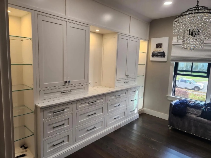 White GFCI electrical outlet with red reset button on a textured wall.