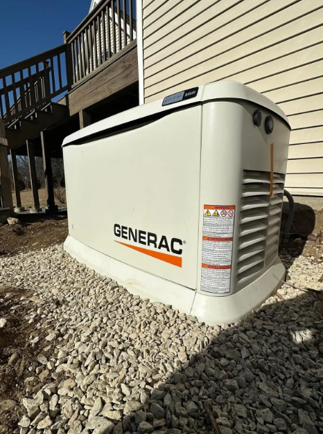 White GFCI electrical outlet with red reset button on a textured wall.