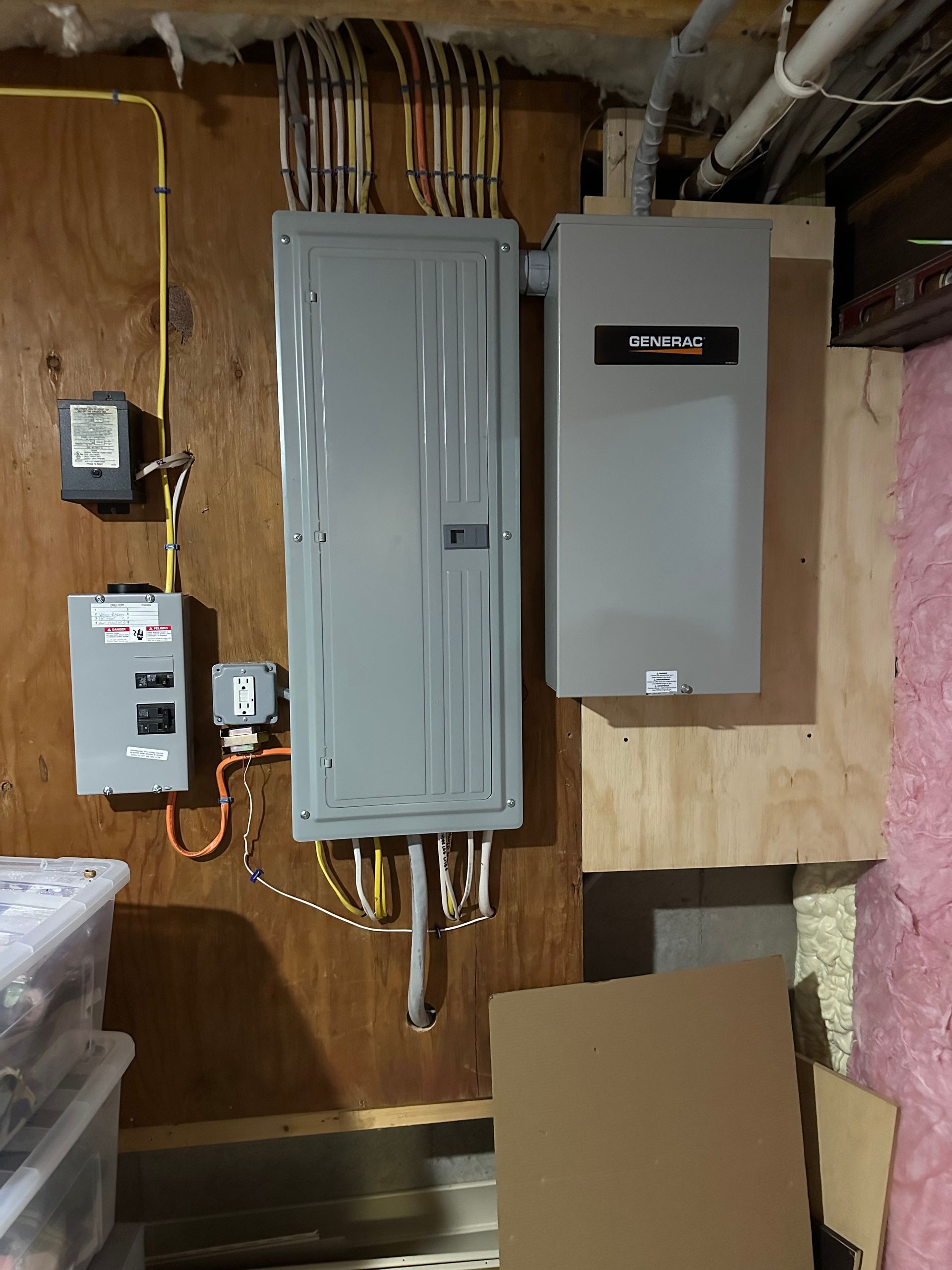 Electrical outlet with burn marks and exposed wiring on a beige wall.