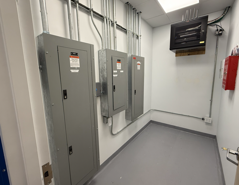 Damaged outdoor electrical outlet with exposed wires, mounted on white siding.