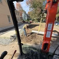 Hand inserting a white outlet cover into an electrical outlet. Beige wall. Hand inserting a white outlet cover into an electrical outlet. Beige wall.