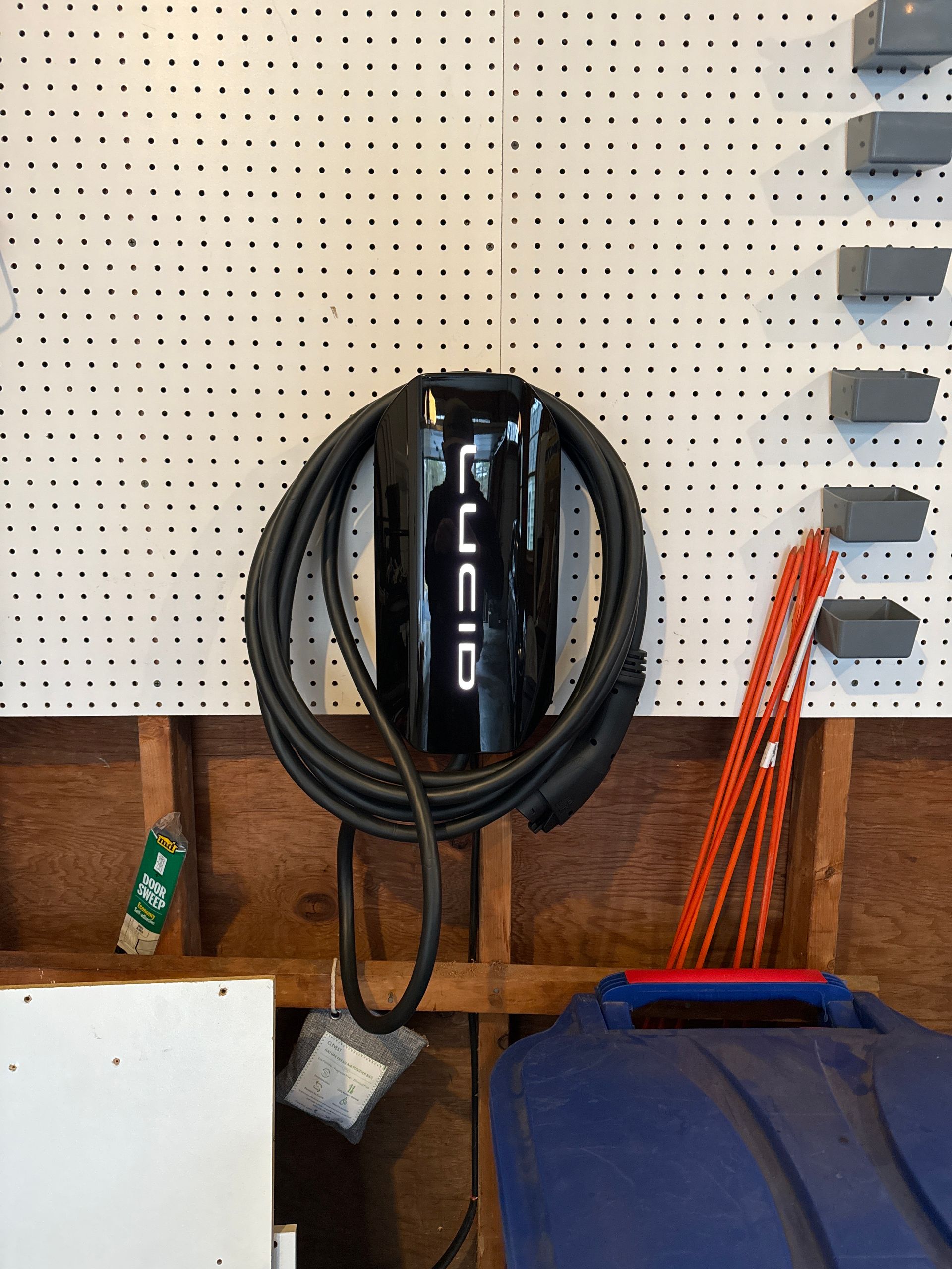 Damaged outdoor electrical outlet with exposed wires, mounted on white siding.