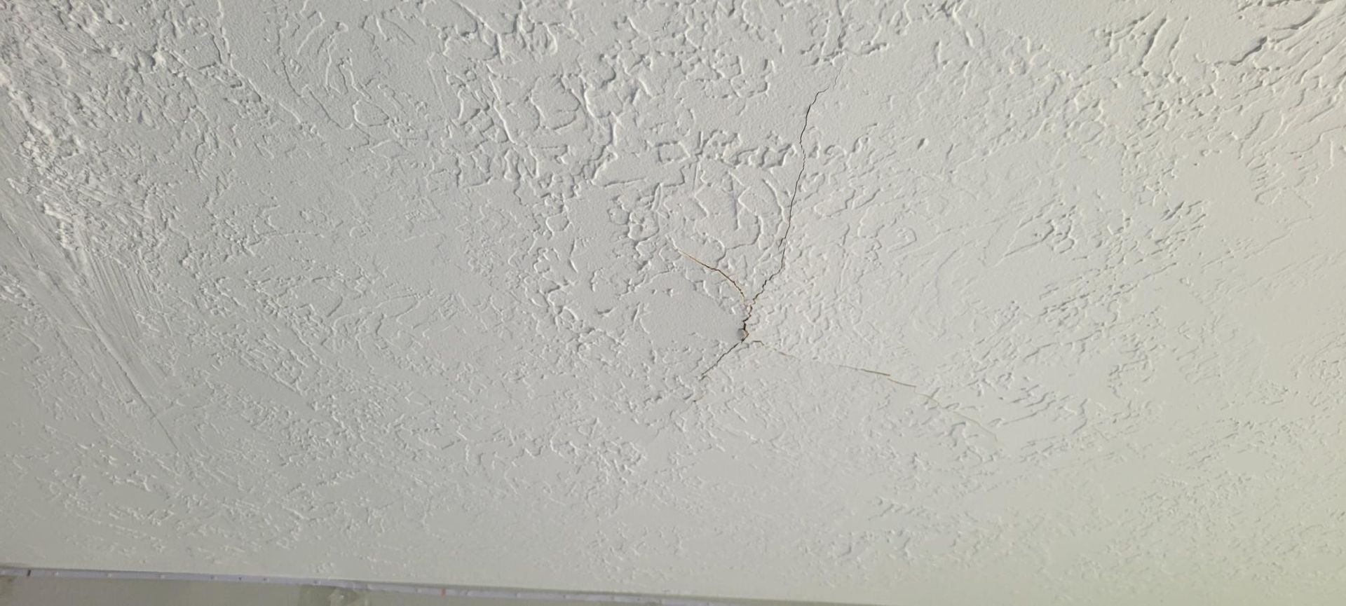 White textured ceiling, likely plaster or drywall.