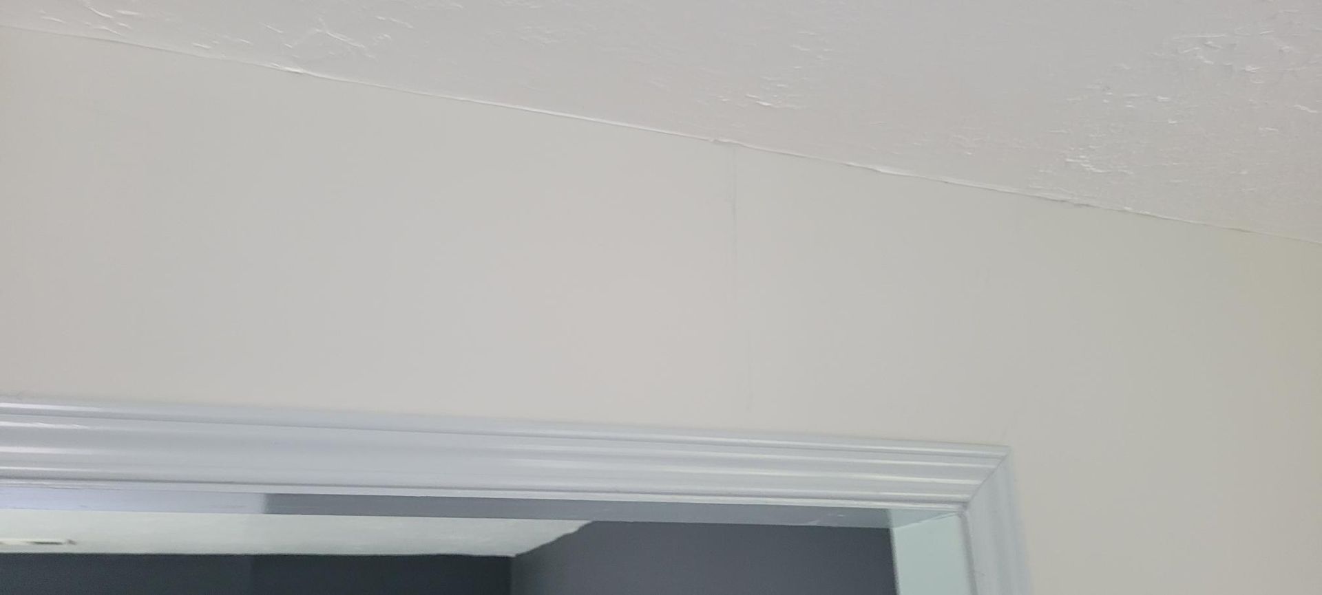 White painted walls and trim frame a doorway.