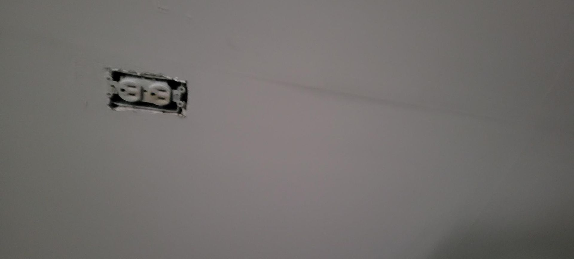 Electrical outlet installed in a painted wall.