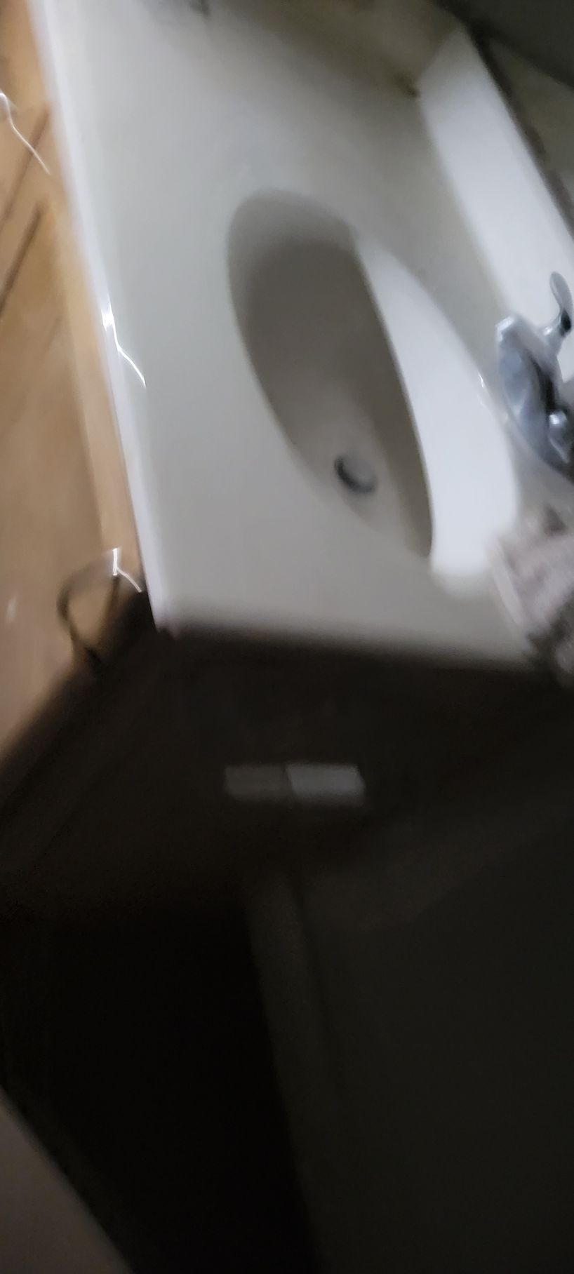 A white toilet bowl with a dark seat.