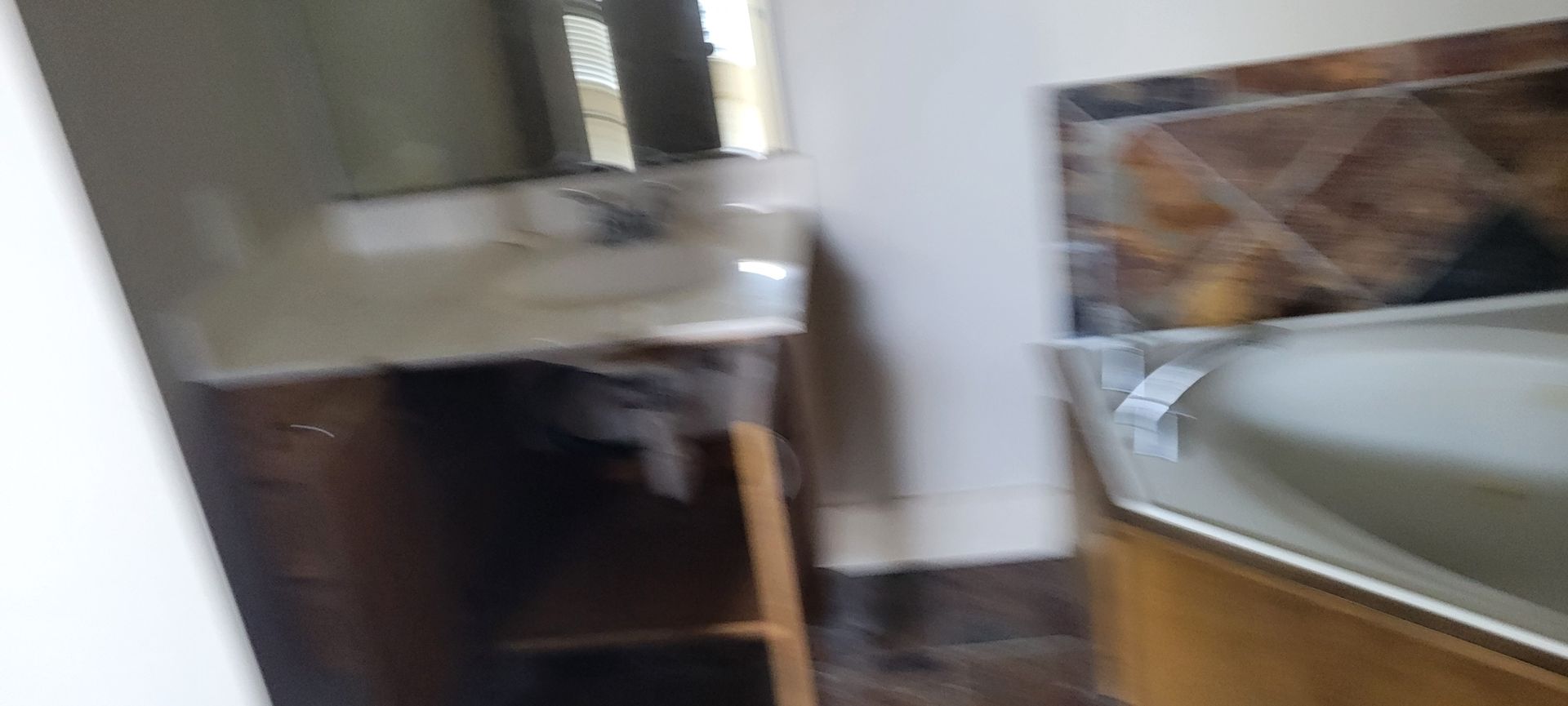 Bathroom interior with a sink, mirror, and bathtub.