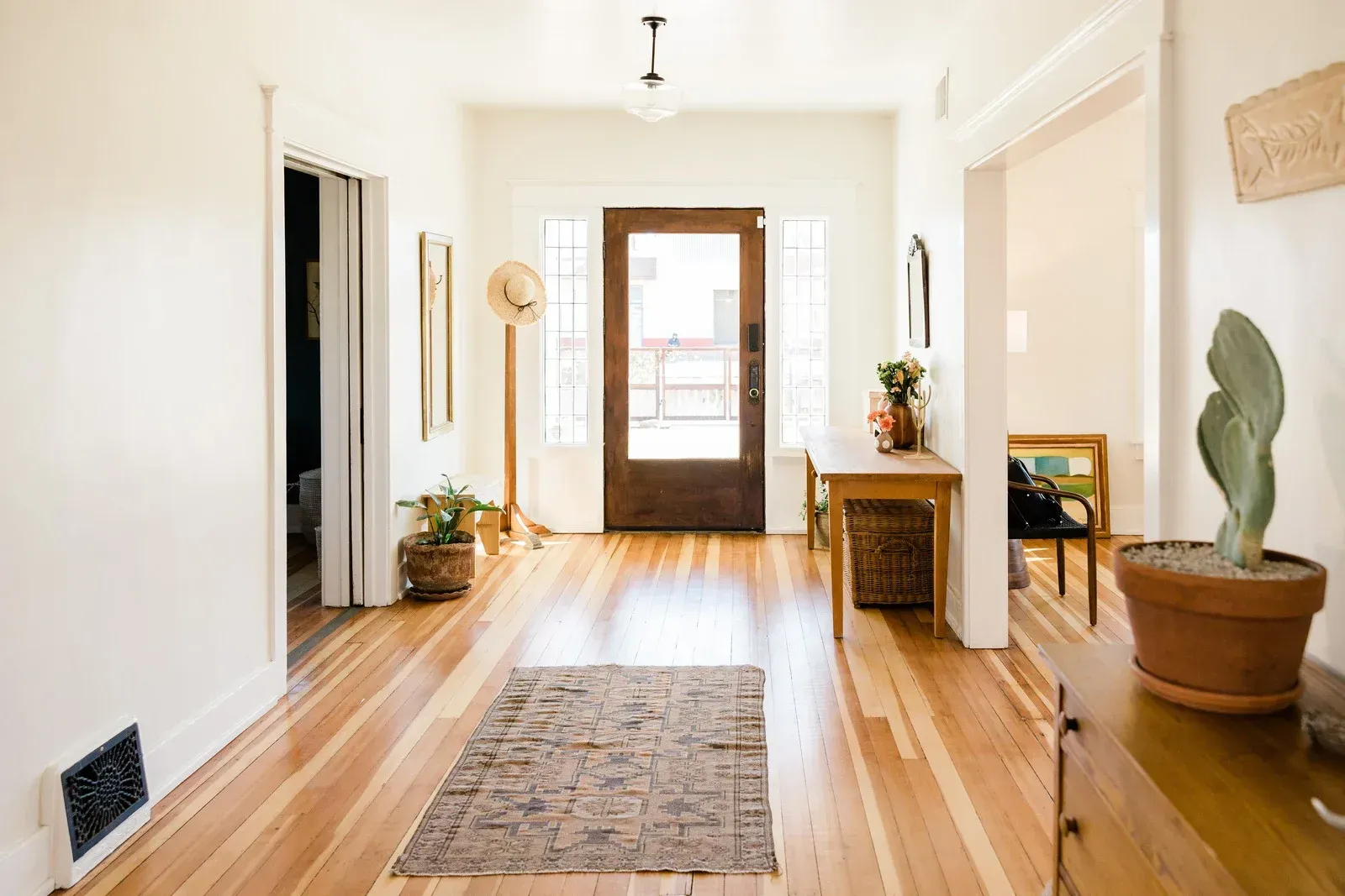 A kitchen with green cabinets , a sink , and a dishwasher.
