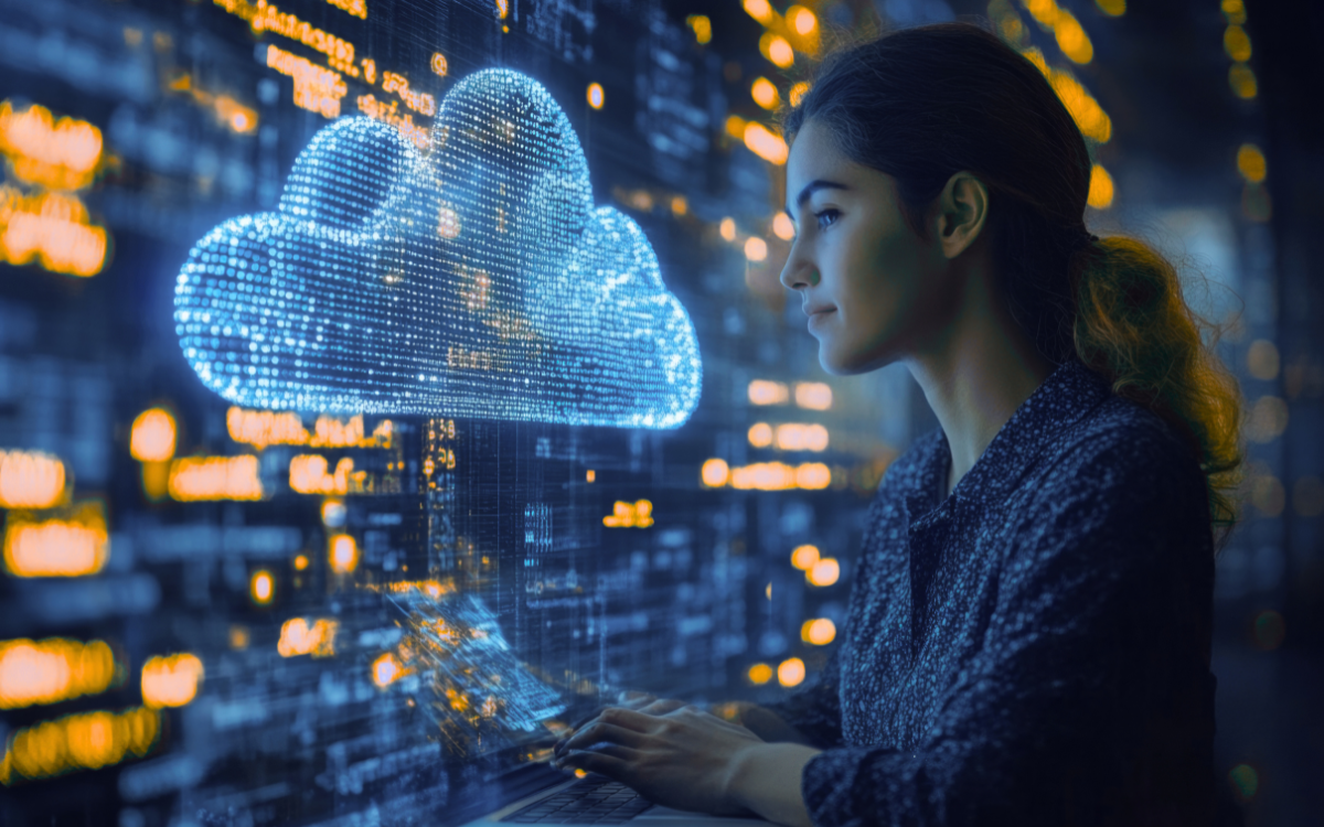 A woman is looking at a cloud on a computer screen.