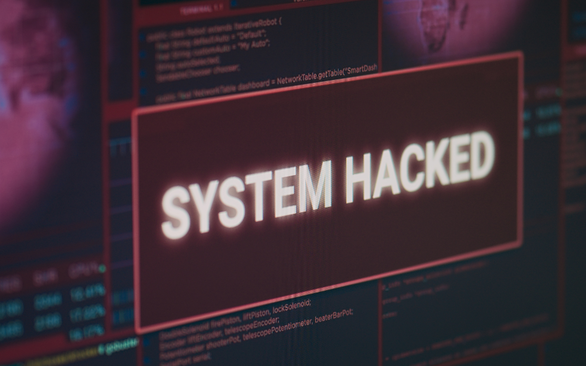 A computer screen displays a message that says system hacked.