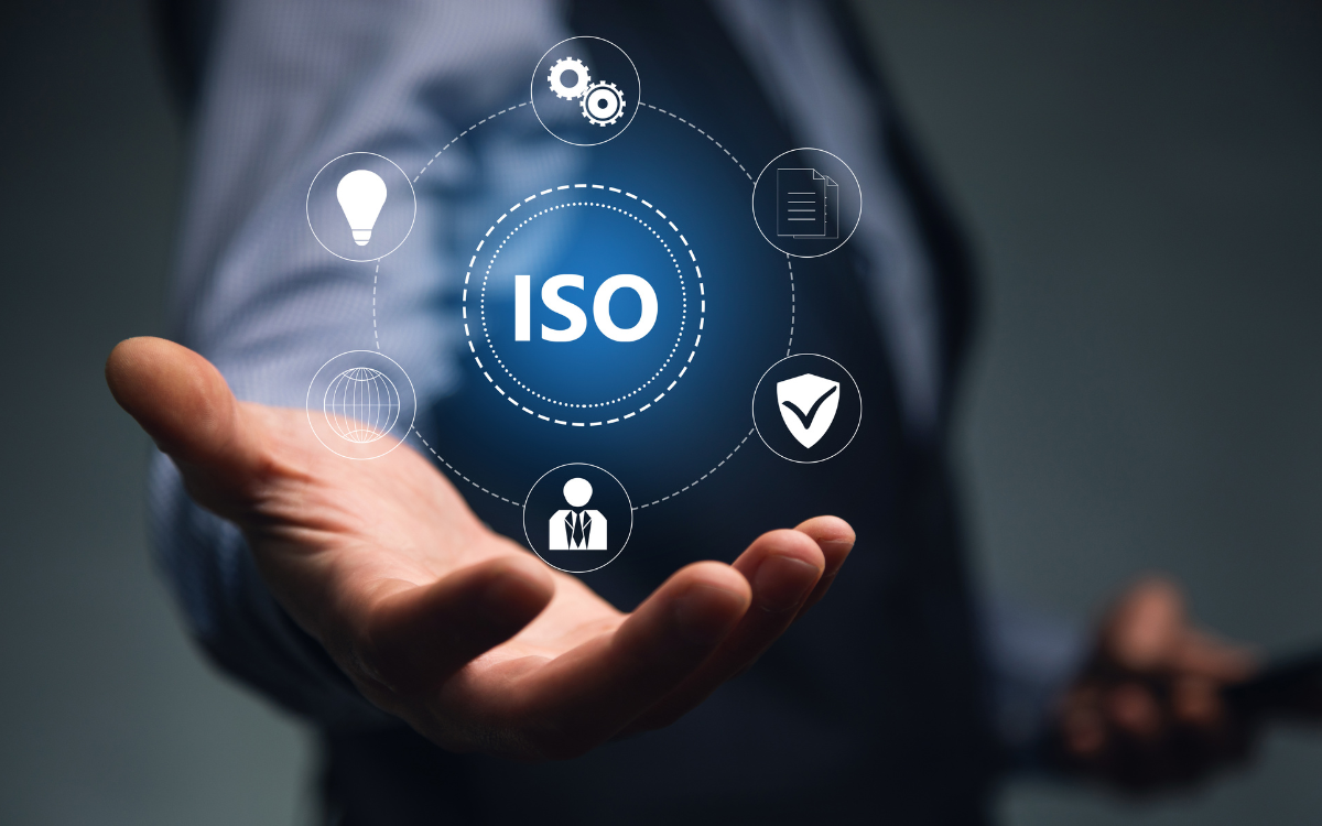 A man is holding a blue ball with the word ISO on it.