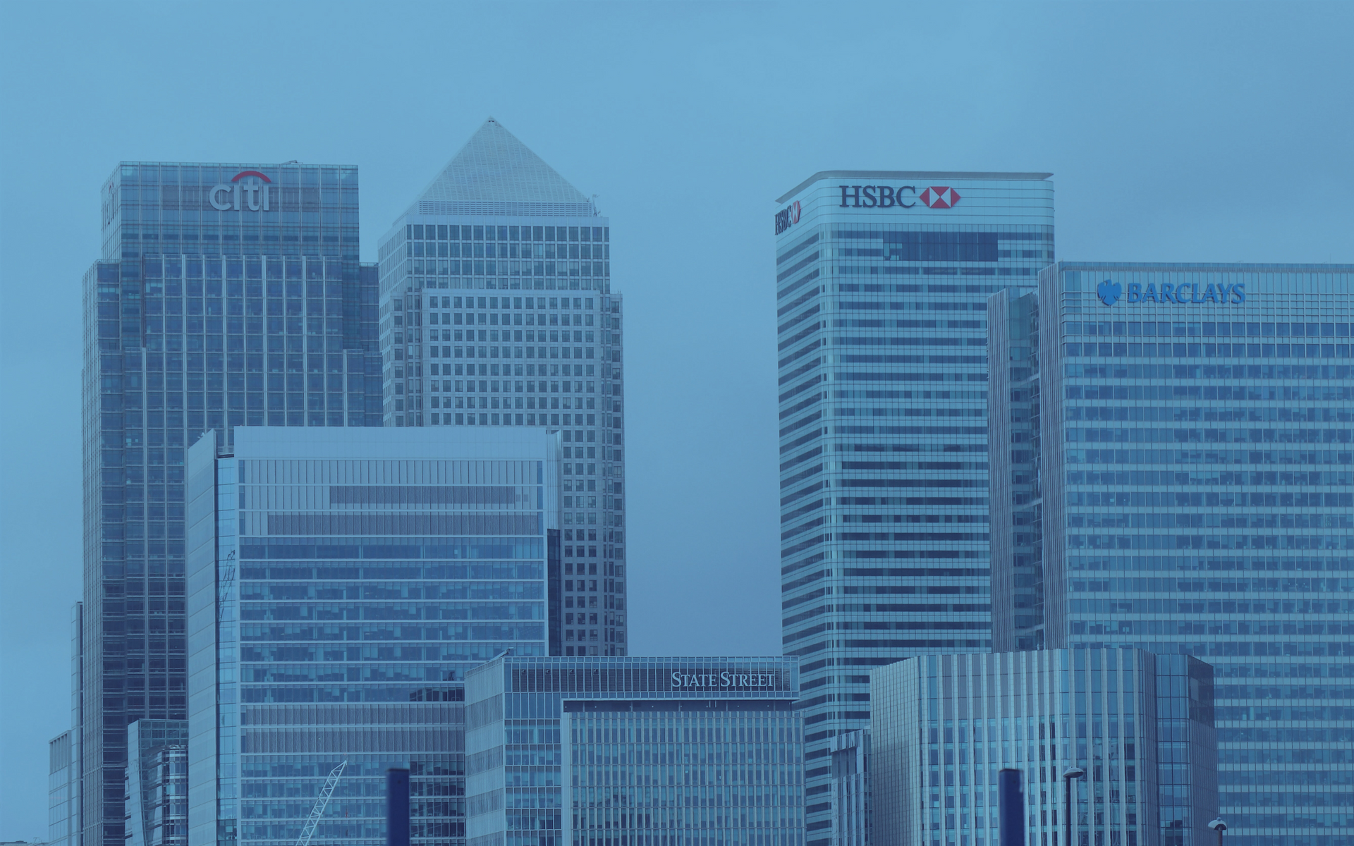 Skyscrapers of Canary Wharf, London, including Citibank, HSBC, and Barclays, tinted blue.
