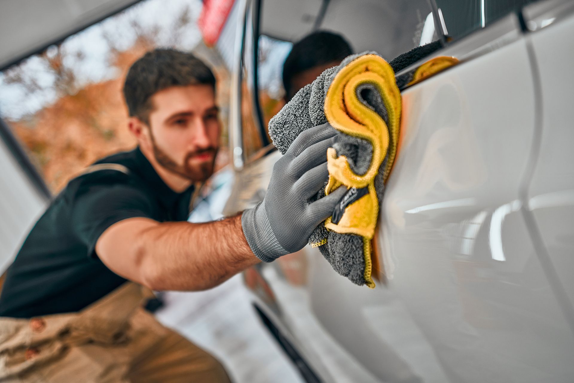 Man Wiping the Door of the White Car — Henrico, VA — Carma Sutra LLC