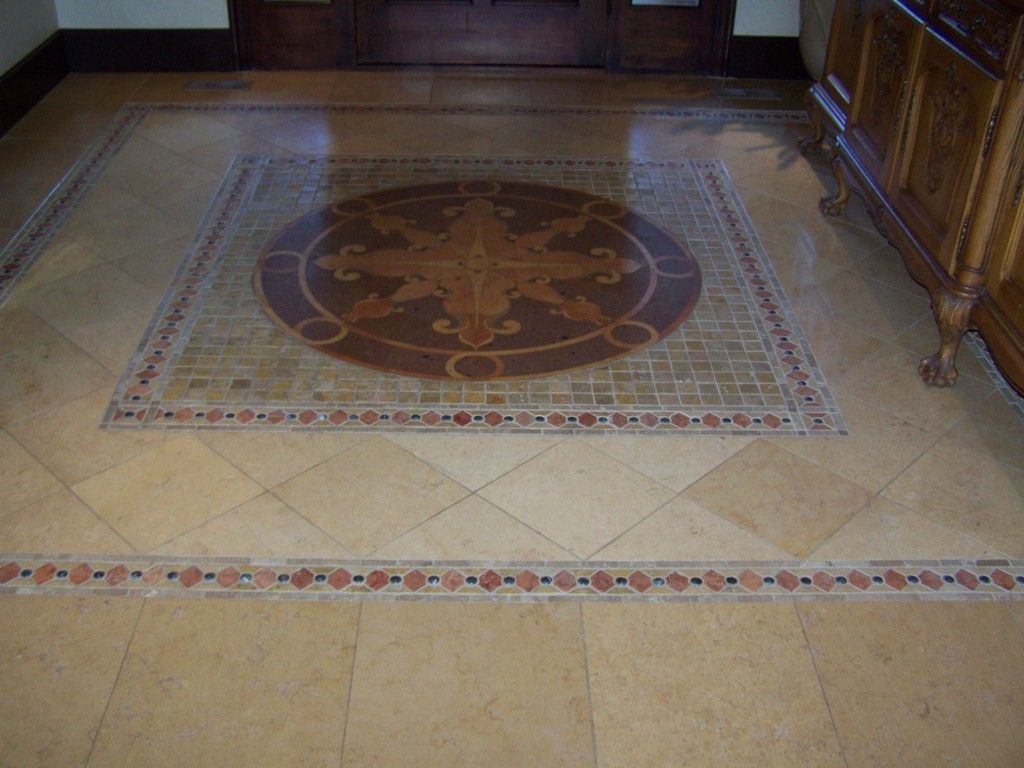 Living room with large arched window, Christmas tree inside, and ceiling fan.