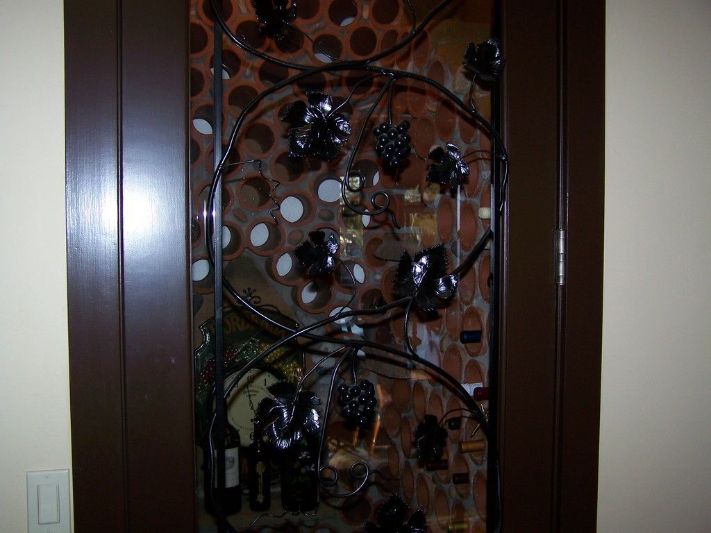 Tile floor with central patterned medallion, bordered by mosaic tiles and a cabinet.