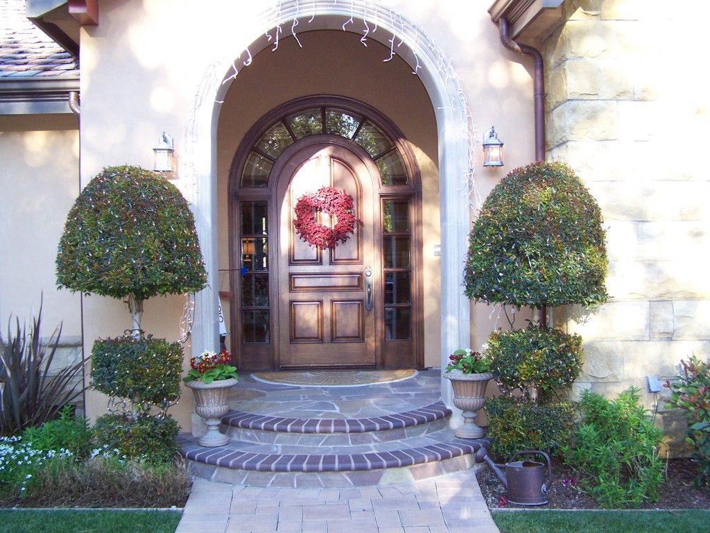 Backyard view of a large house with a pool and patio furniture.