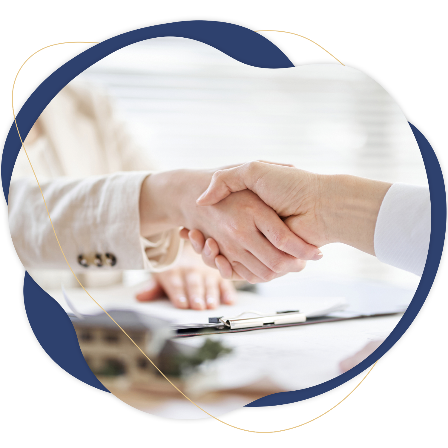 Two people shaking hands over a clipboard on a desk.