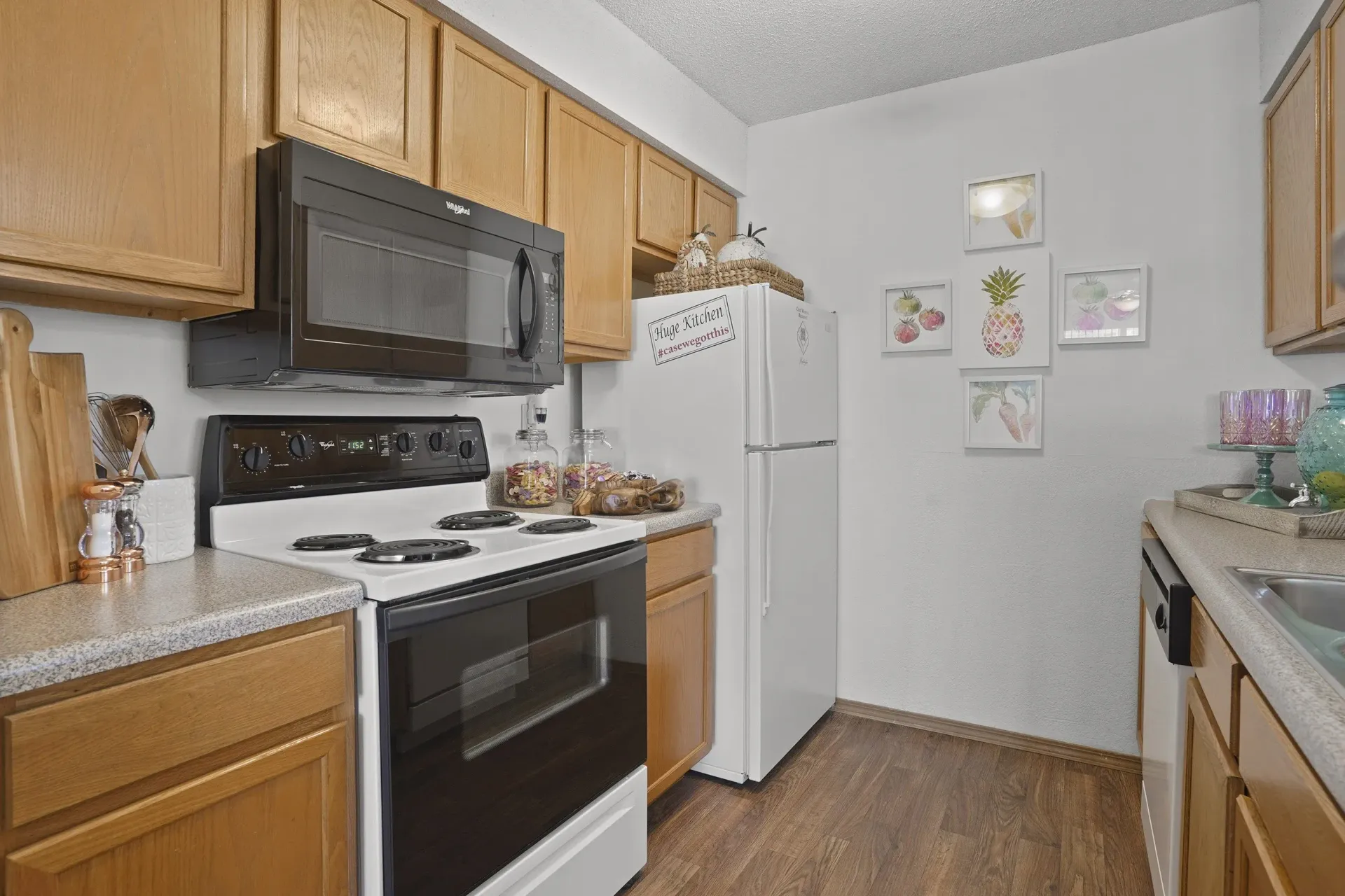 A kitchen with wooden cabinets and a white refrigerator.