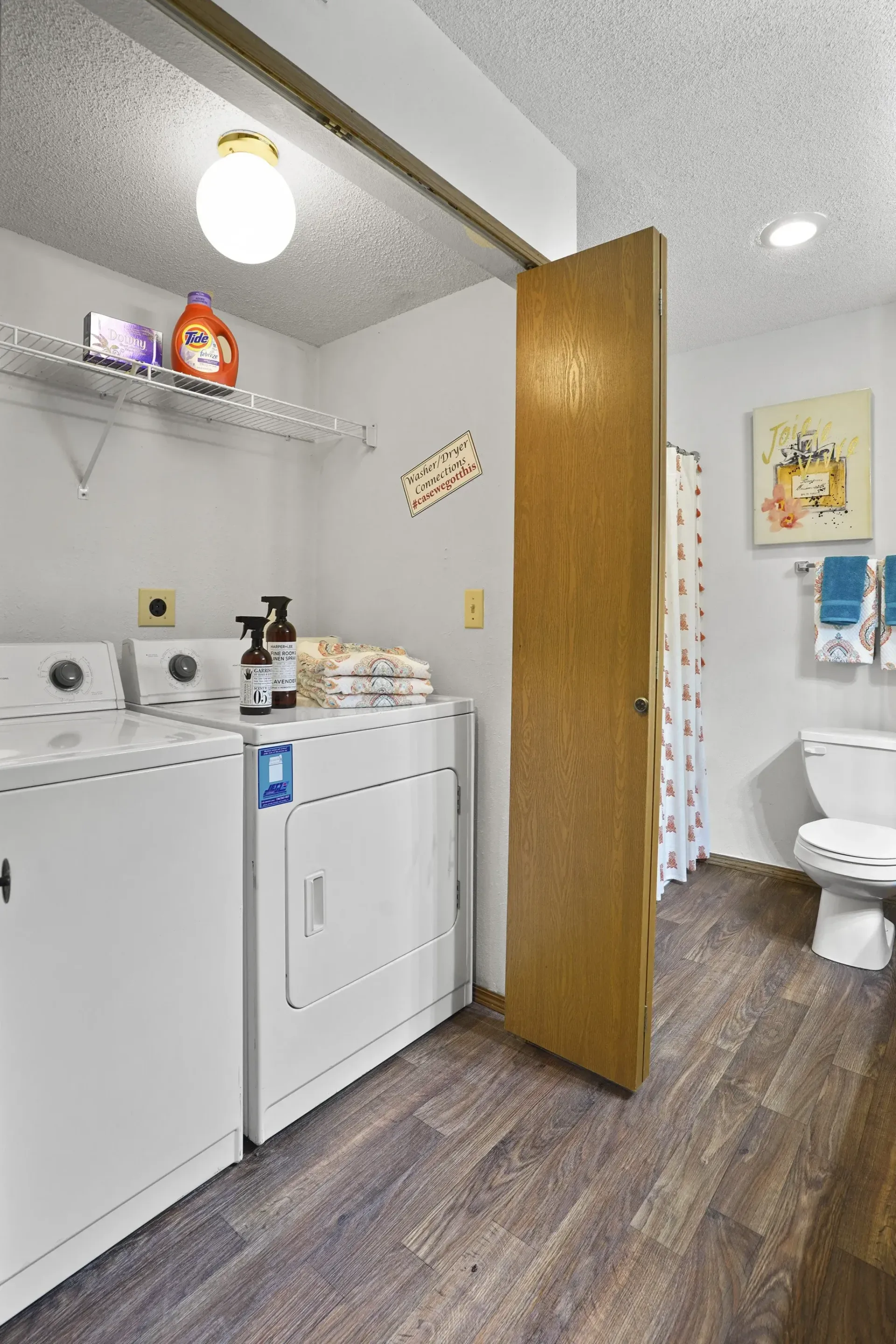 A small bathroom with a washer and dryer.