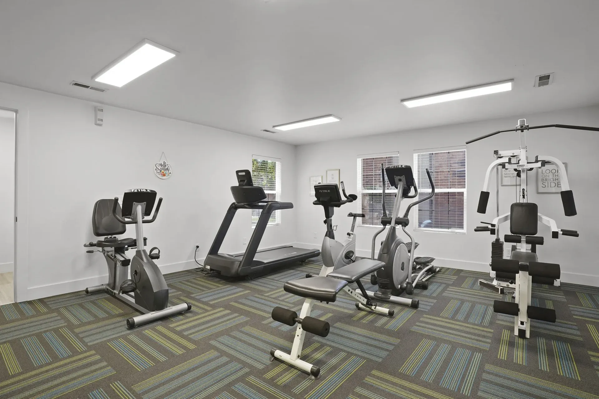 A gym with a variety of exercise equipment.