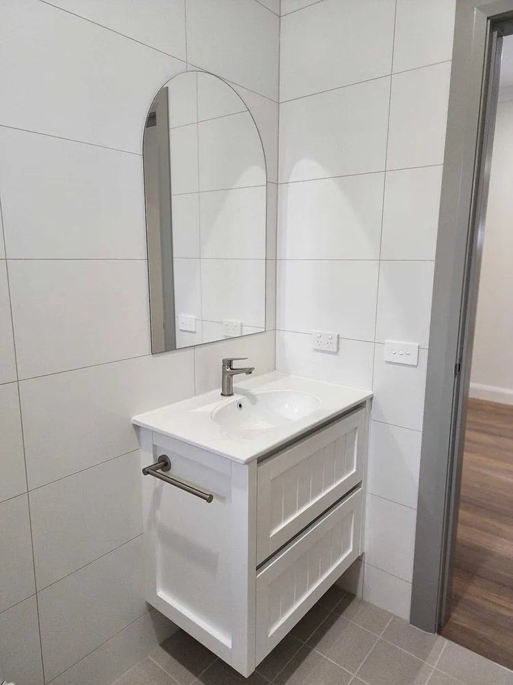 A Bathroom With a Sink and a Mirror — Chandolin Construction in Bathurst, NSW