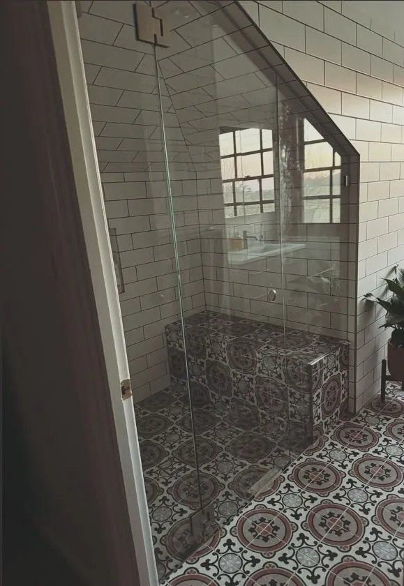 A Bathroom With a Walk in Shower and a Tiled Floor — Chandolin Construction in Bathurst, NSW