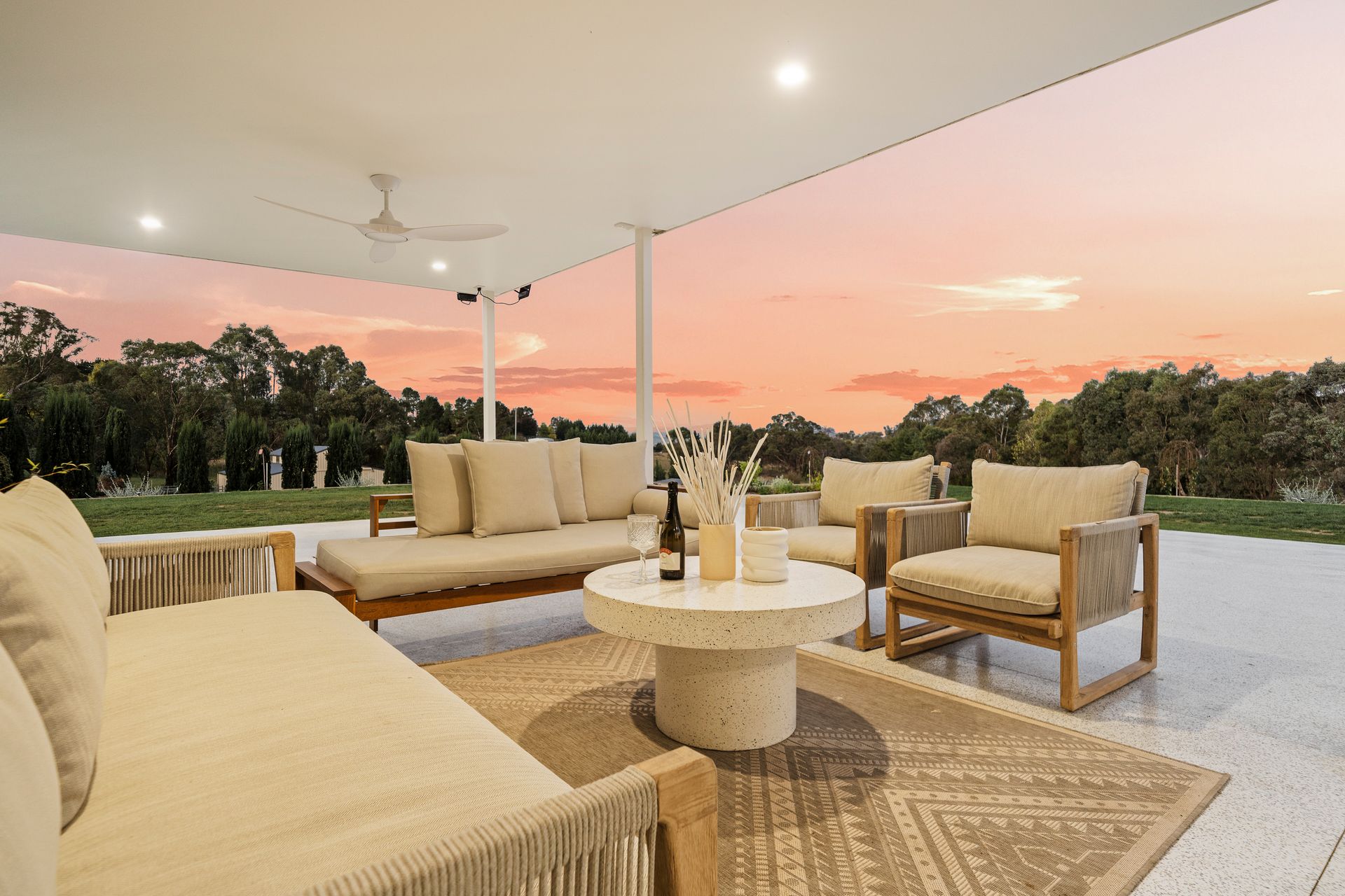 A Man is Kneeling in the Dirt in Front of a Brick House — Chandolin Construction in Bathurst, NSW