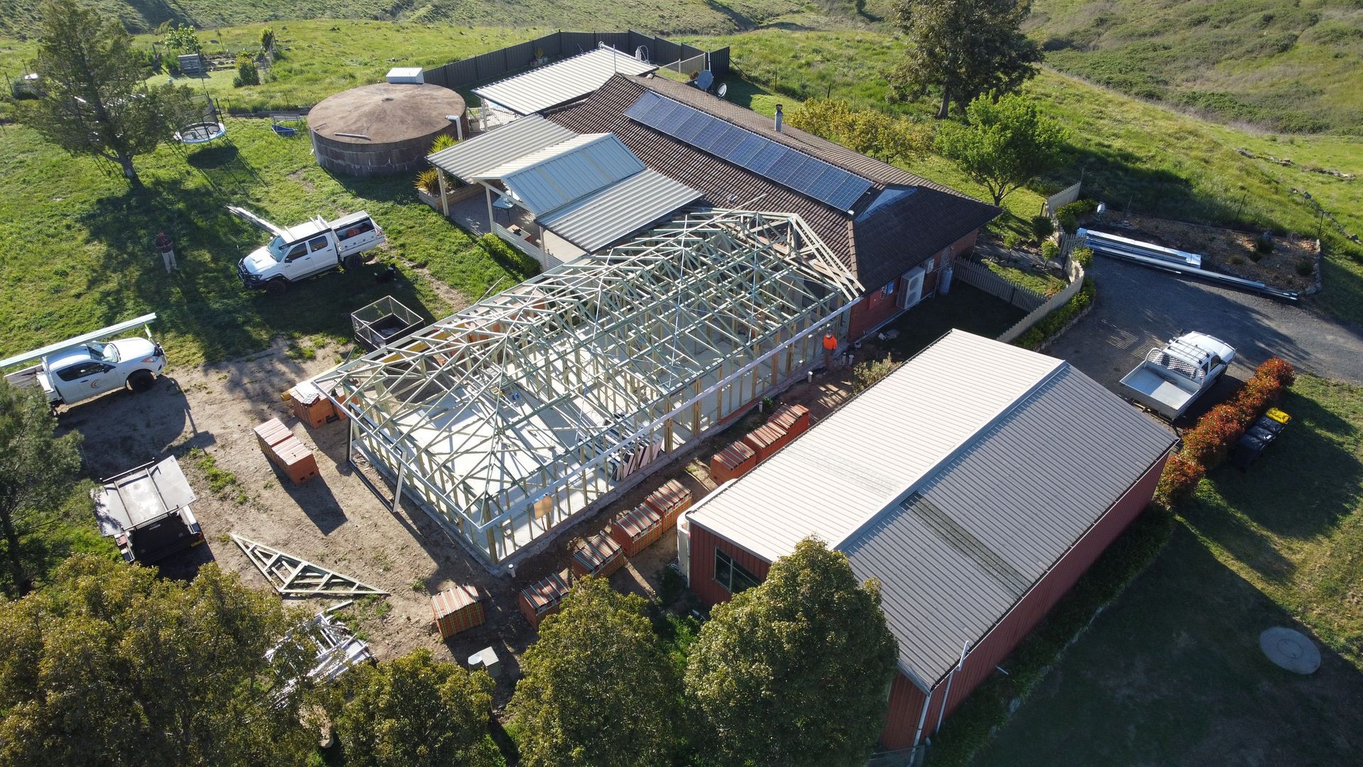 Building Under Construction with Wooden Framework and Adjacent Completed Structure — Chandolin Construction in Bathurst, NSW
