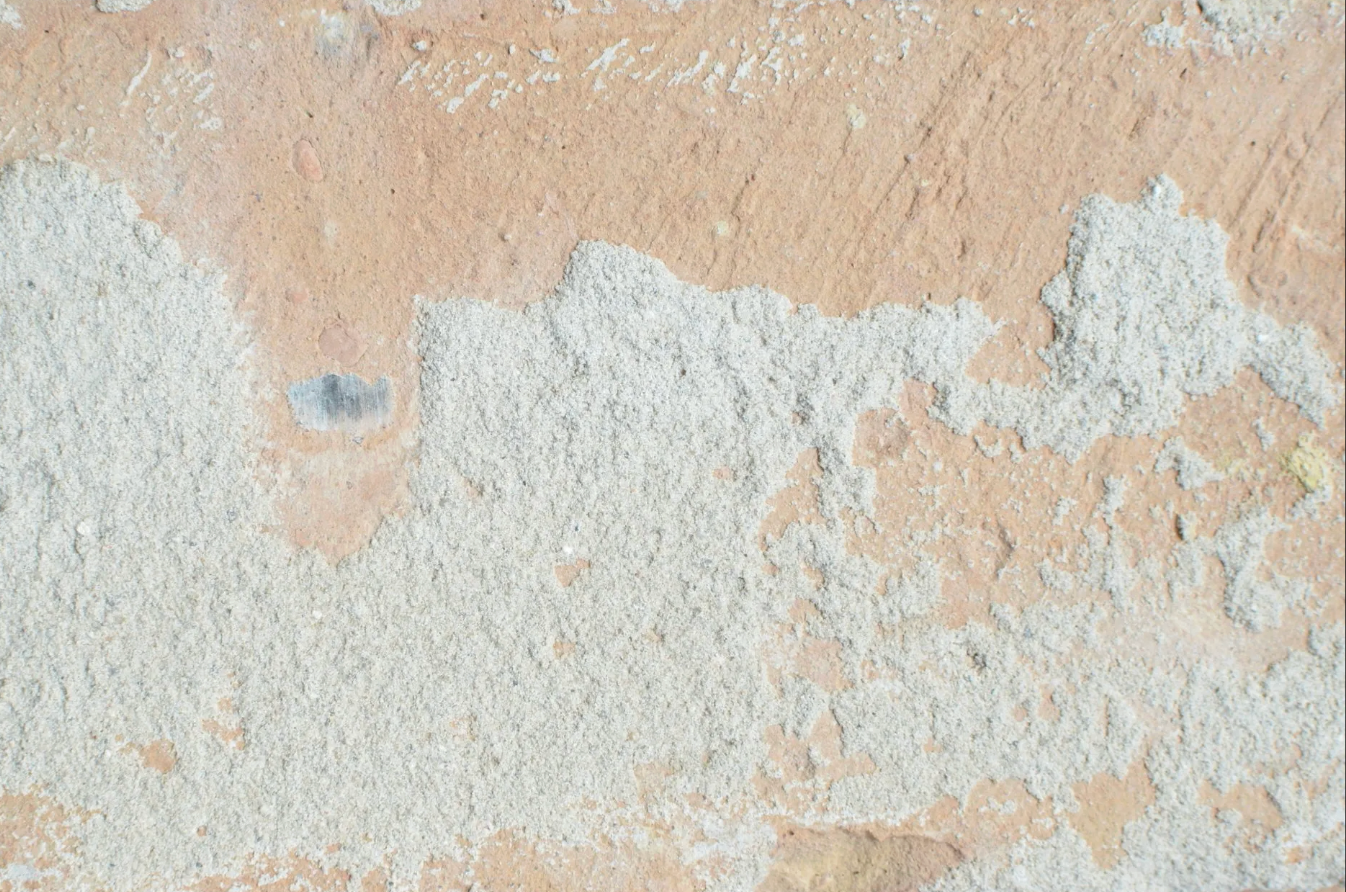 A close up of a white surface with a grainy texture.