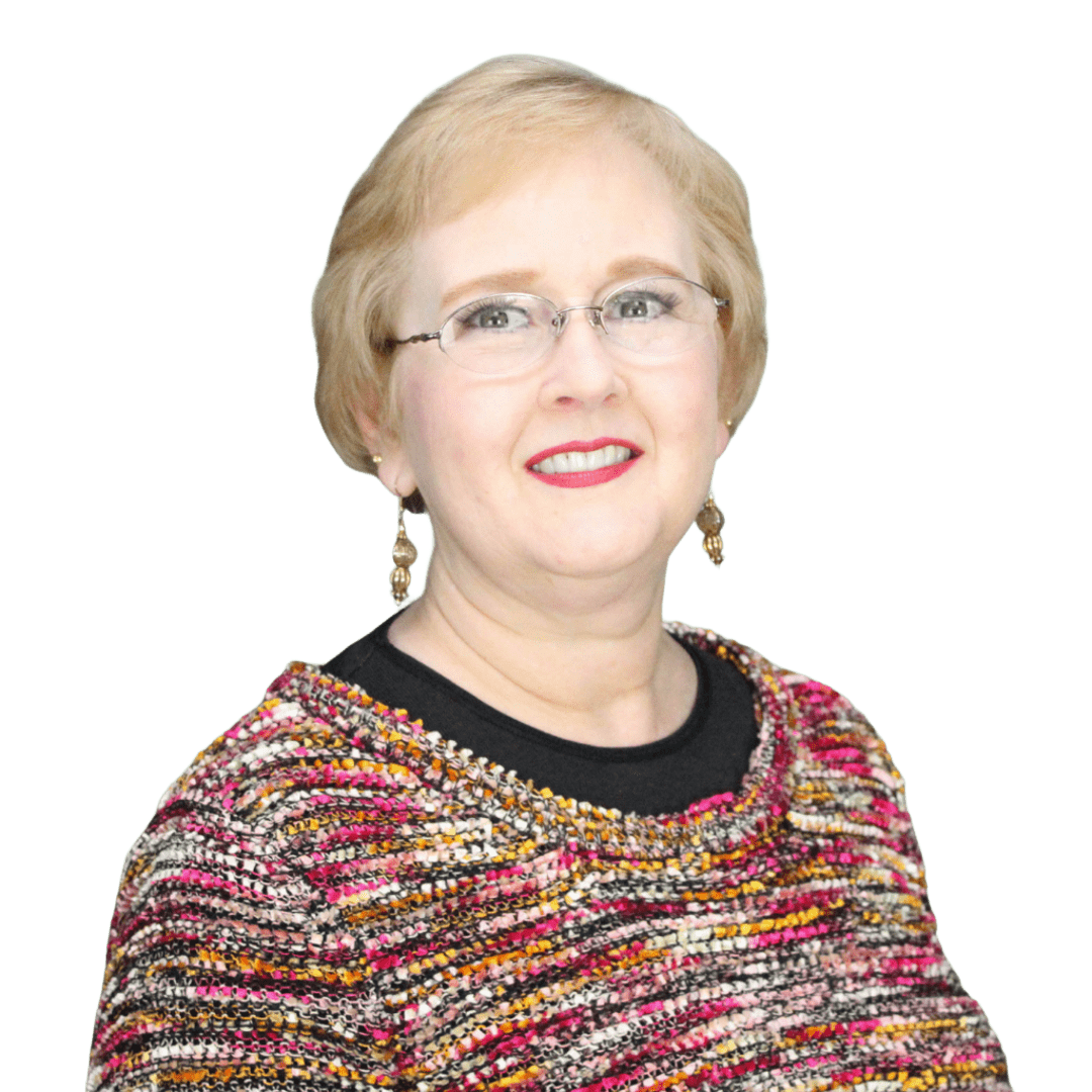 A woman wearing glasses and a colorful sweater is smiling for the camera.