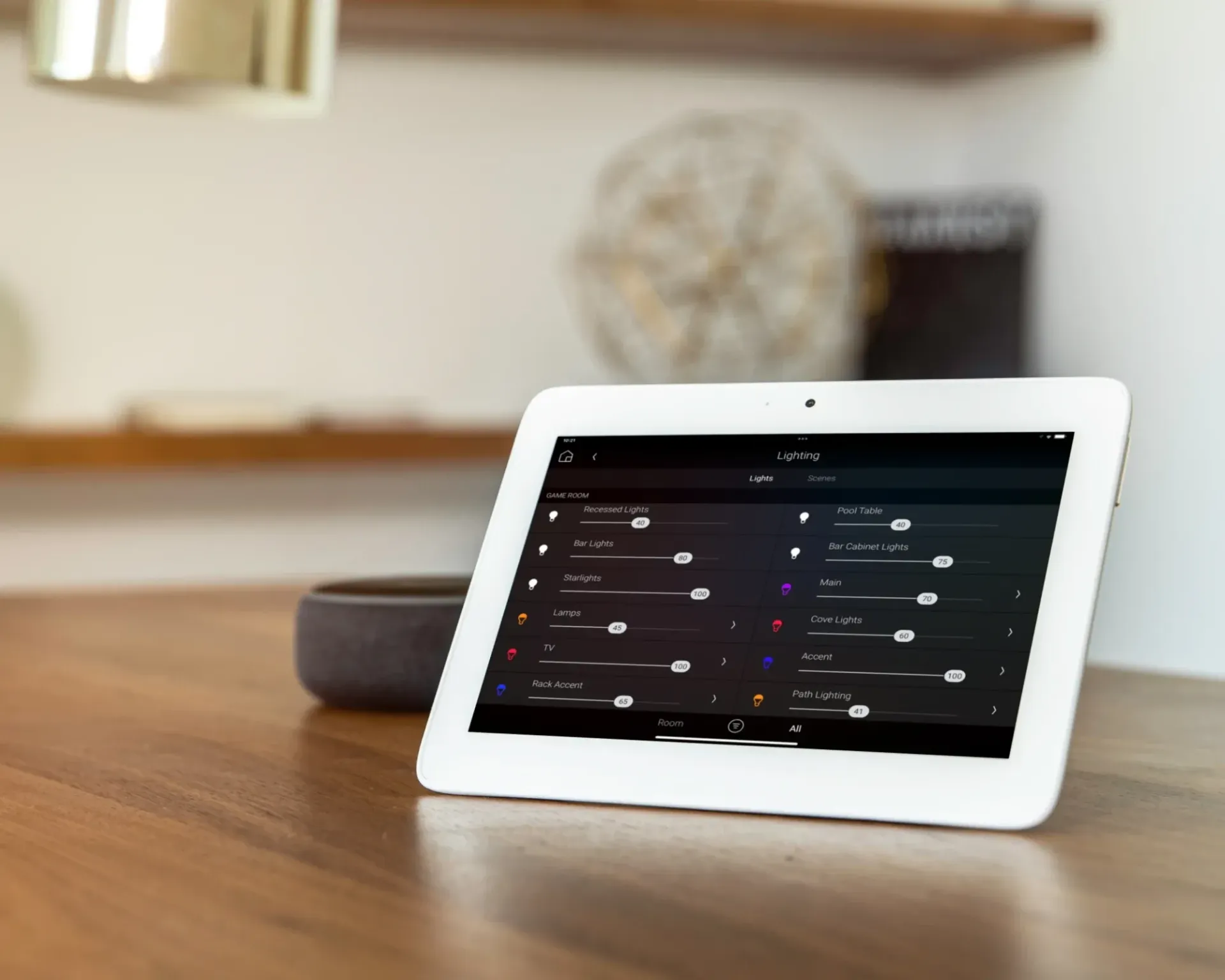A white tablet is sitting on a wooden table