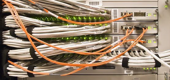 A bunch of wires are connected to a server in a data center.