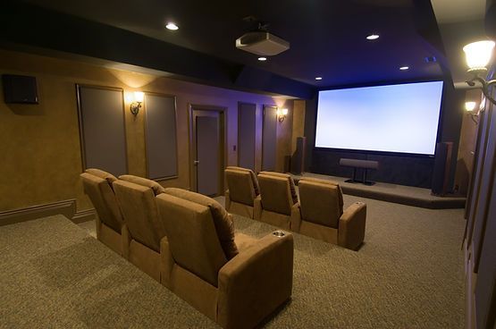 A home theater with a large screen and a projector.