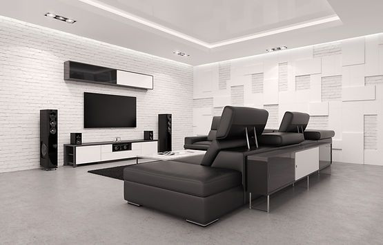 A living room with a couch , television , speakers and a flat screen tv.