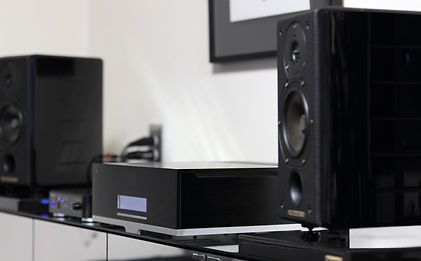 A couple of speakers sitting on top of a glass table.