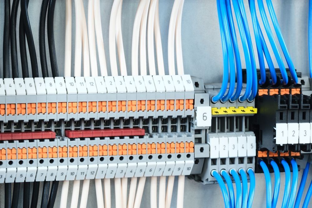 A close up of a electrical box with lots of wires and connectors.