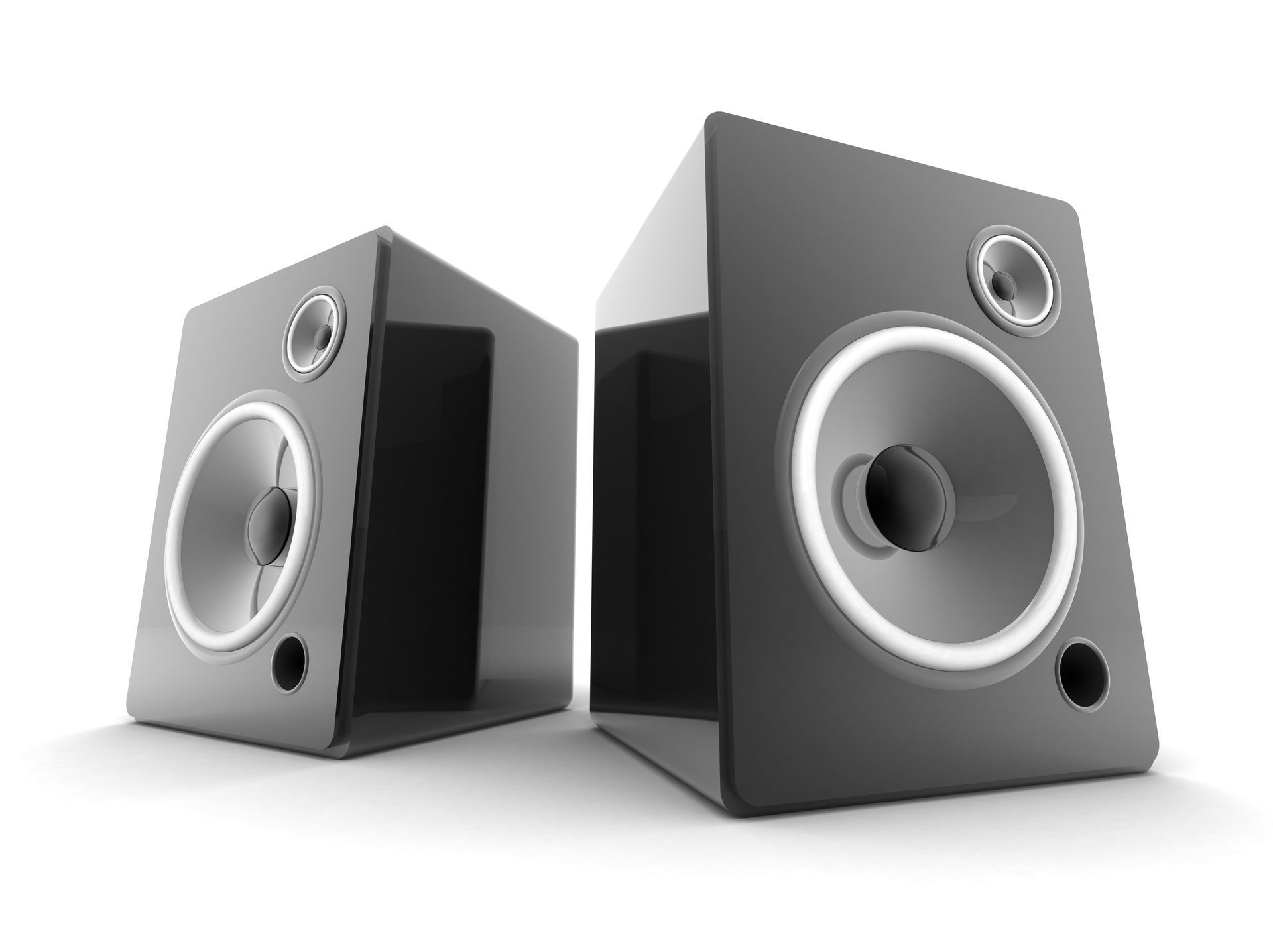 A couple of speakers sitting on top of a glass table.