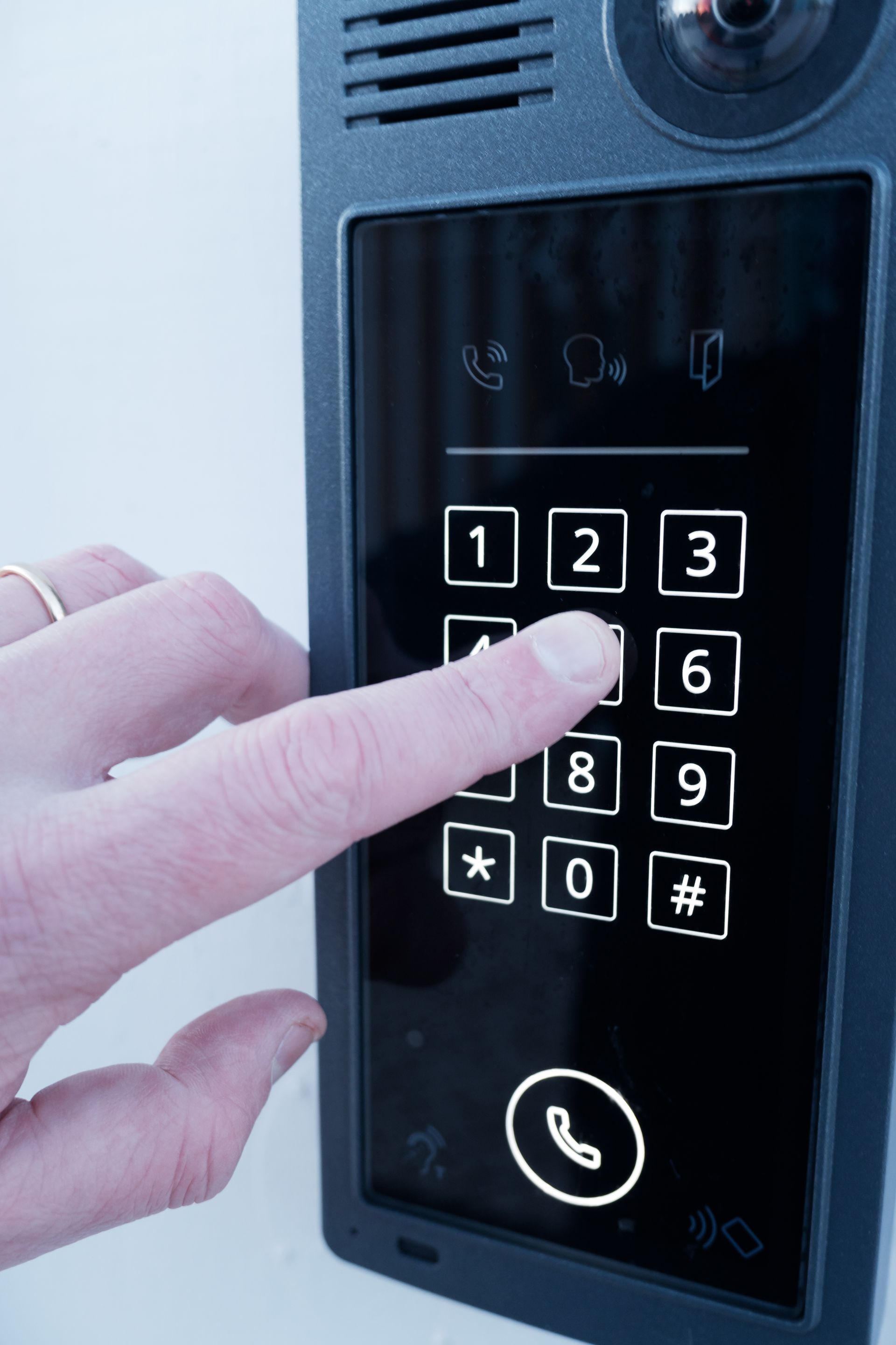 A keypad is attached to the side of a fence.