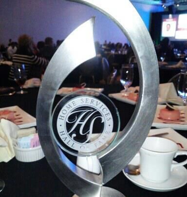 A home services hall of fame trophy sits on a table