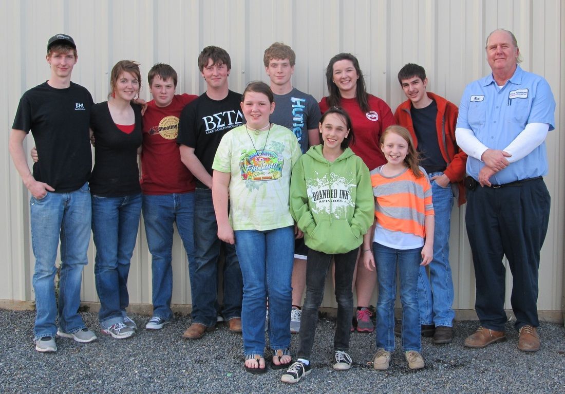 A group of people posing for a picture with one wearing a shirt that says just do it