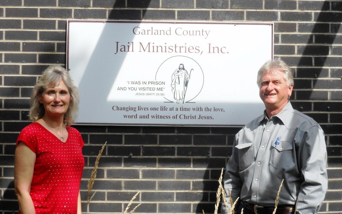 employee and representative standing in front of Garland County Jail Ministries sign